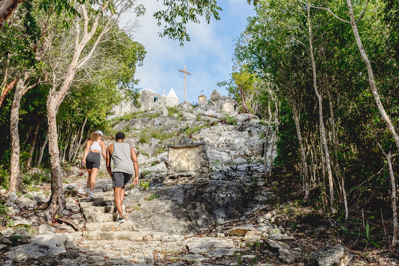 Walkers climbing the rocky path to the Hermitage on Mount Alvernia, Cat Island
