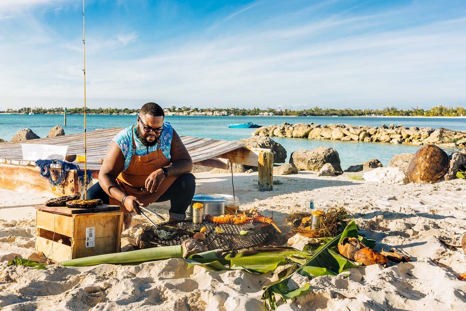 A private chef preparing seafood on a beach in Nassau
